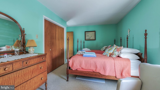 bedroom featuring light colored carpet and a closet