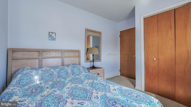 bedroom featuring light carpet and a closet