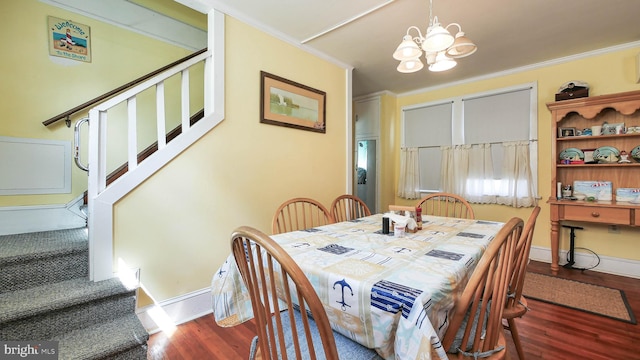 dining space with a notable chandelier, ornamental molding, and dark wood-type flooring