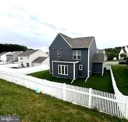 back of house with a yard and a garage