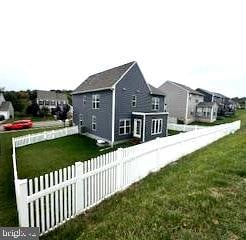 view of side of home featuring a lawn