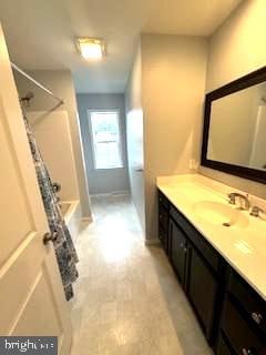 bathroom with vanity and shower / bath combination with curtain