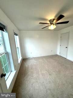 unfurnished room with carpet and ceiling fan