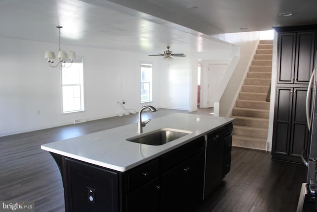 kitchen with dark wood-type flooring, plenty of natural light, a center island with sink, and sink