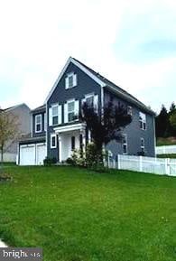 rear view of house with a yard