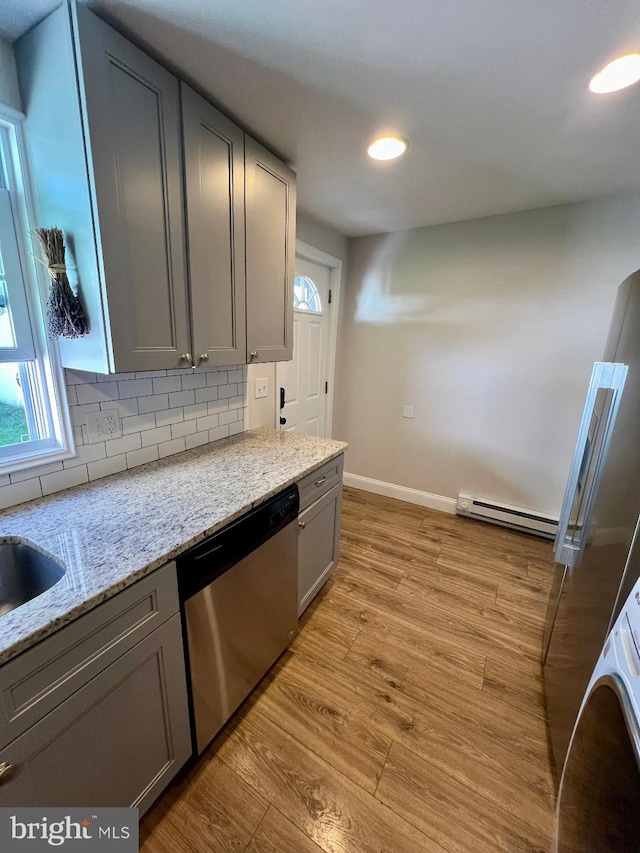 kitchen featuring gray cabinets, light hardwood / wood-style flooring, and dishwasher