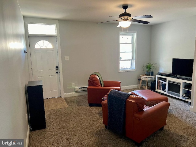 living room featuring ceiling fan, carpet floors, and a baseboard heating unit