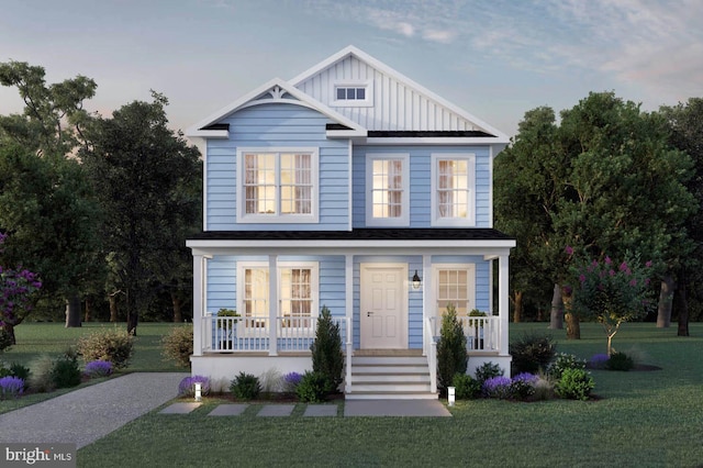 view of front of house with a yard and covered porch