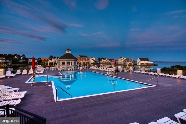 pool at dusk with a water view