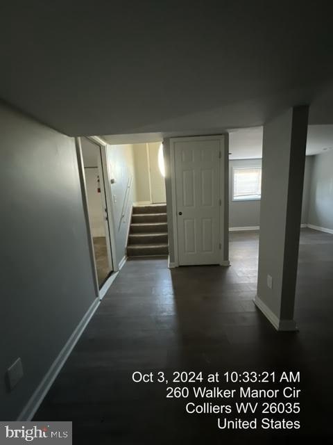 hallway with dark hardwood / wood-style floors