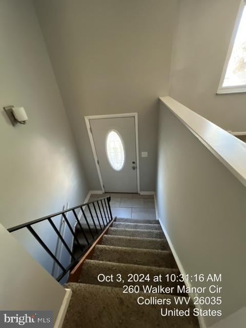 stairs featuring tile patterned floors