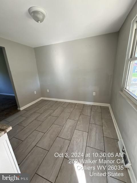 unfurnished room with hardwood / wood-style flooring