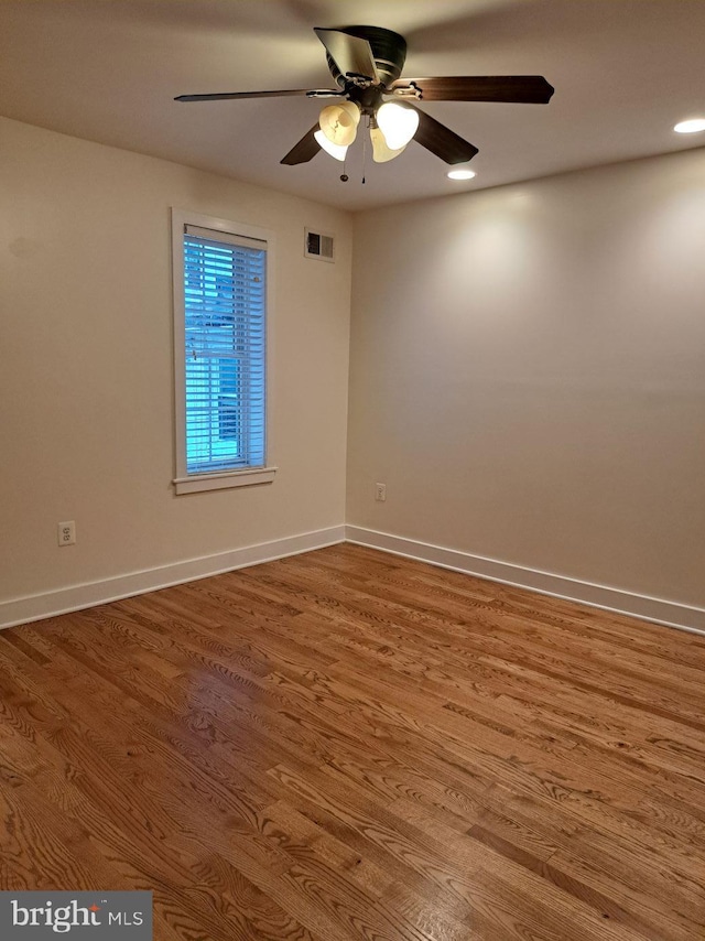 empty room with ceiling fan and hardwood / wood-style floors