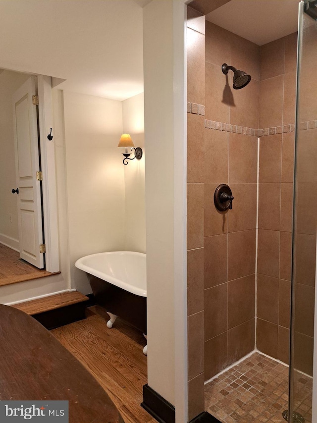 bathroom featuring wood-type flooring and separate shower and tub