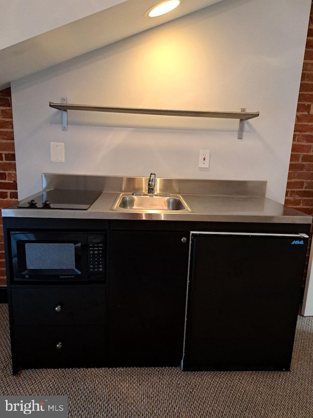 kitchen featuring light carpet, vaulted ceiling, sink, and black appliances