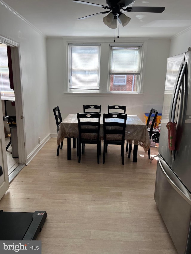 dining room with ceiling fan, light hardwood / wood-style flooring, and ornamental molding