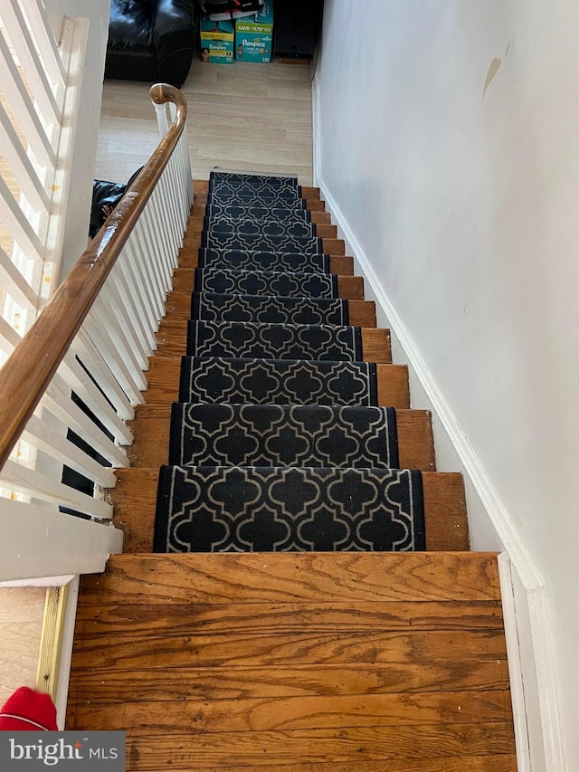 staircase featuring hardwood / wood-style flooring