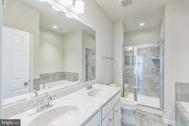 full bathroom featuring tile patterned floors, independent shower and bath, vanity, and toilet