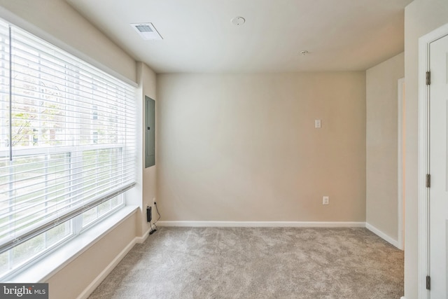 carpeted empty room with electric panel