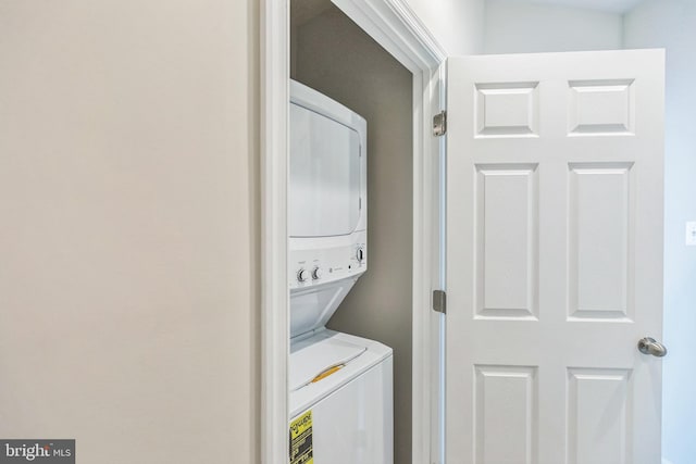 washroom featuring stacked washer and dryer