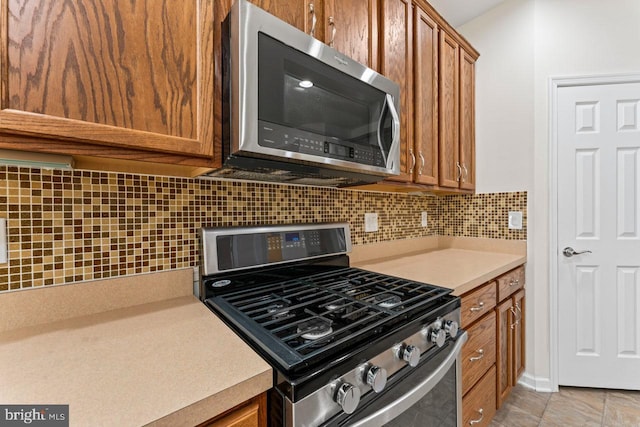 kitchen featuring stainless steel appliances and tasteful backsplash