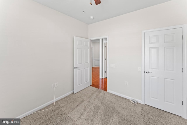 unfurnished bedroom featuring ceiling fan and carpet floors