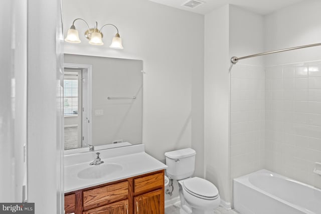 full bathroom featuring tiled shower / bath combo, vanity, and toilet