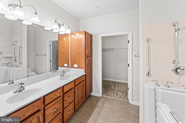 bathroom with vanity and tiled shower