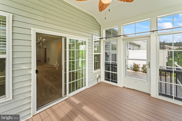 unfurnished sunroom featuring ceiling fan and vaulted ceiling