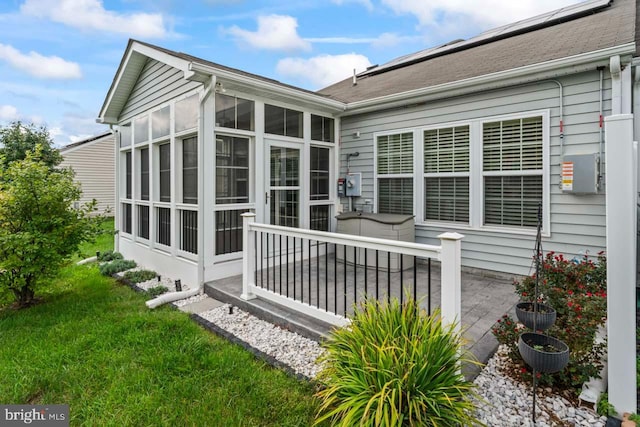 exterior space featuring a yard and a sunroom