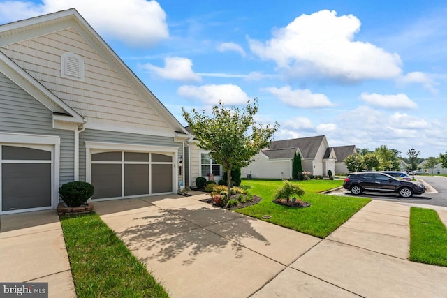 view of front of property featuring a garage and a front lawn