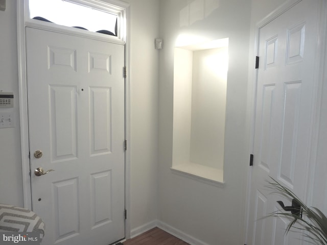 doorway with dark hardwood / wood-style flooring