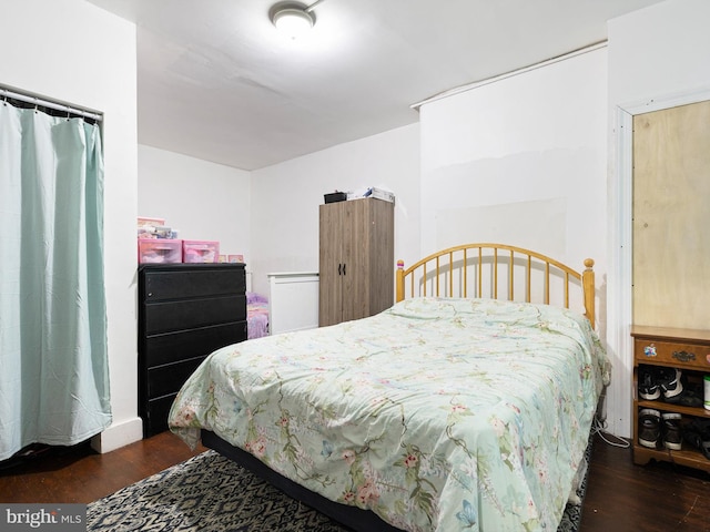 bedroom featuring dark wood-type flooring