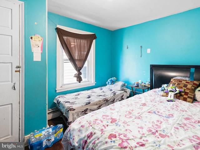 bedroom featuring a baseboard heating unit