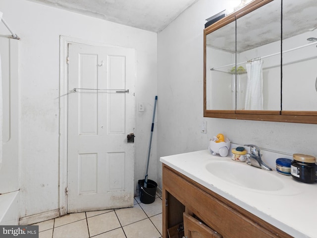 bathroom featuring vanity, tile patterned floors, and walk in shower