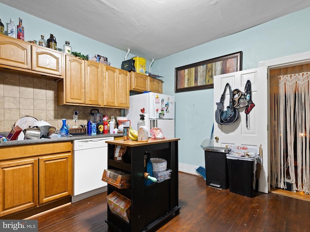 kitchen featuring white appliances, backsplash, and dark hardwood / wood-style flooring