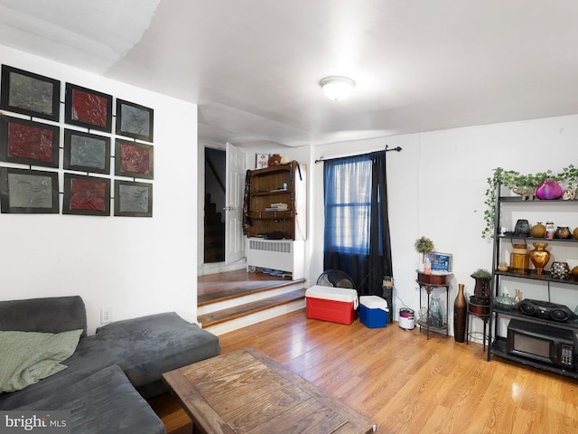 living room featuring radiator heating unit and wood-type flooring