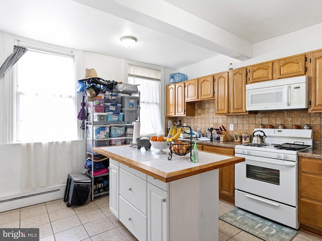 kitchen featuring decorative backsplash, light tile patterned floors, tile countertops, a kitchen island, and white appliances