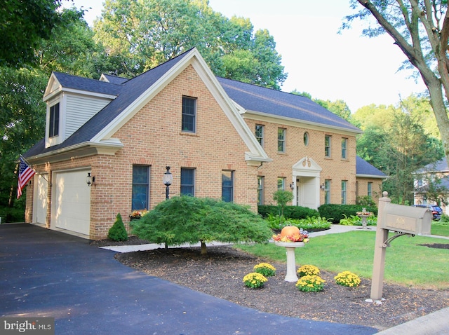 view of front of home featuring a front yard and a garage