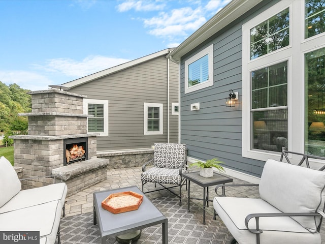 view of patio / terrace with an outdoor living space with a fireplace