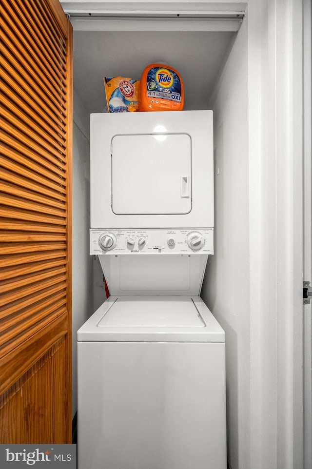 washroom with stacked washer and clothes dryer