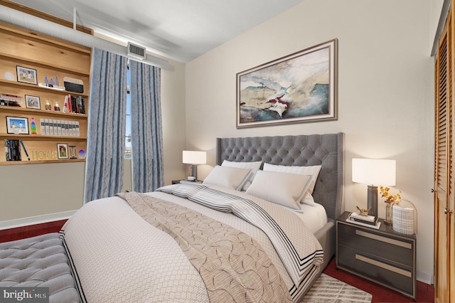 bedroom with a closet and dark hardwood / wood-style flooring