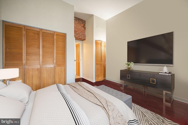 bedroom featuring hardwood / wood-style flooring, a closet, and a high ceiling