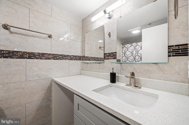 bathroom featuring tile walls, a shower with curtain, and vanity