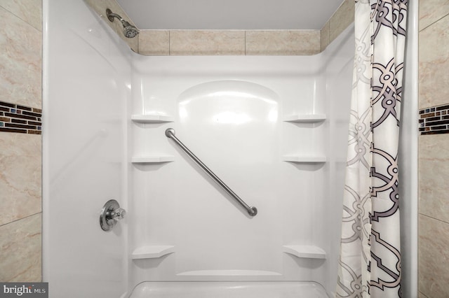 bathroom with walk in shower and tile walls