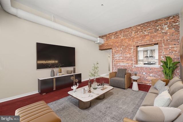 living room with wood-type flooring and brick wall