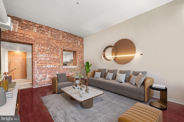 living room featuring brick wall and hardwood / wood-style floors