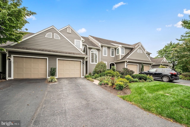 view of front of house featuring a garage and a front lawn