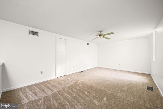 empty room featuring ceiling fan and carpet floors