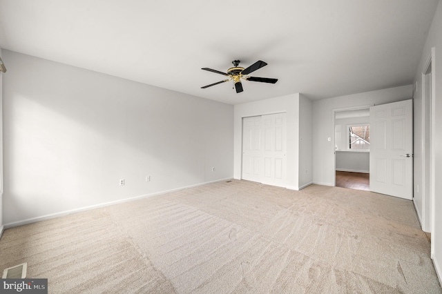 unfurnished bedroom with a closet, ceiling fan, and carpet flooring